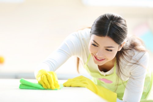 Cleaner removing construction dust from kitchen surfaces
