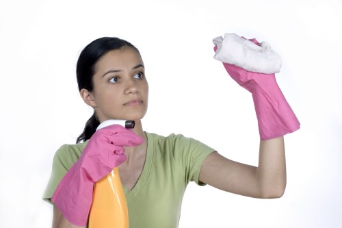 Protective gloves and warning sign used during floor cleaning